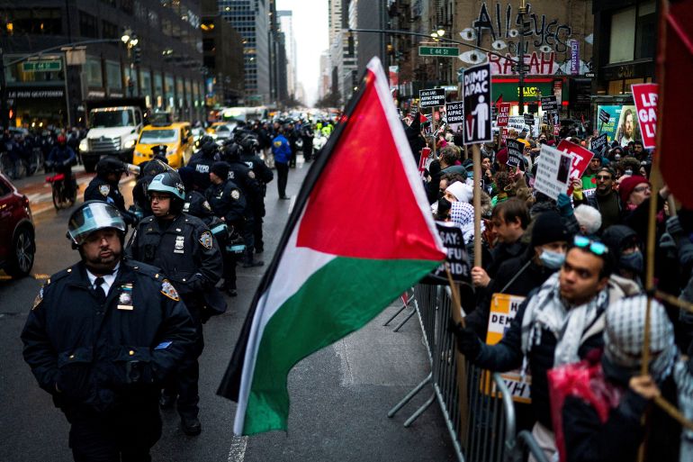 New York Police officers keep an eye on protesters near the AIPAC offices while they rally demanding a ceasefire and the end of Israel's attacks on Gaza, in New York City, U.S., February 22, 2024. REUTERS/Eduardo Munoz