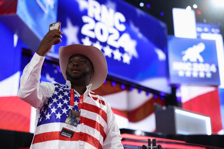 A man at the Republican National Convention. He is wearing a shirt decorated with the US fag and a cowboy hat.