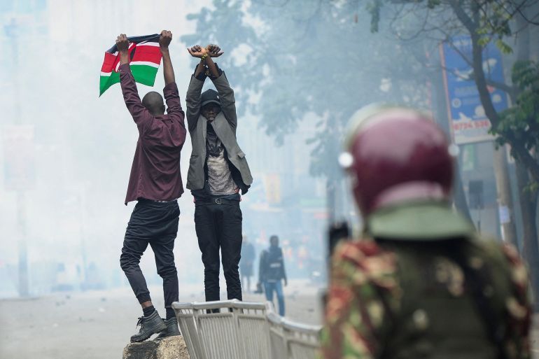 Protestors gesture during an anti-government demonstration, following nationwide deadly riots over tax hikes and a controversial now-withdrawn finance bill