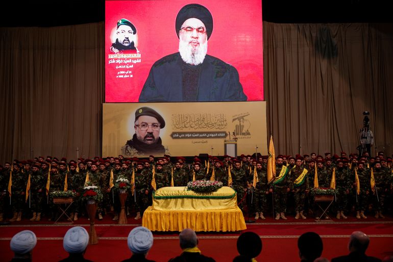 Lebanon's Hezbollah leader Sayyed Hassan Nasrallah addresses his supporters via a video