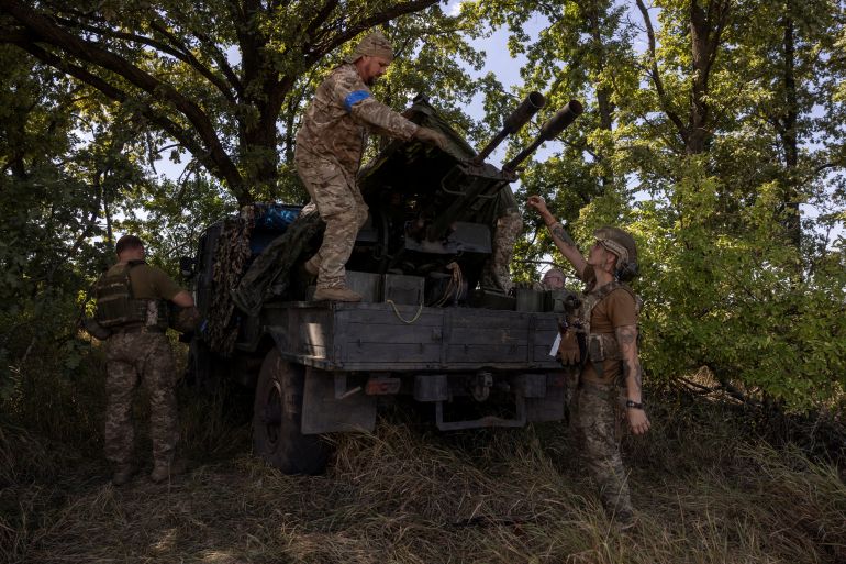 A soldier of Ukraine's 22nd Separate Mechanised Brigade covers up a ZU-23-2 anti-aircraft cannon during an exercise in the Sumy region near the Russian border, amid Russia's attack on Ukraine, August 17, 2024. REUTERS/Thomas Peter