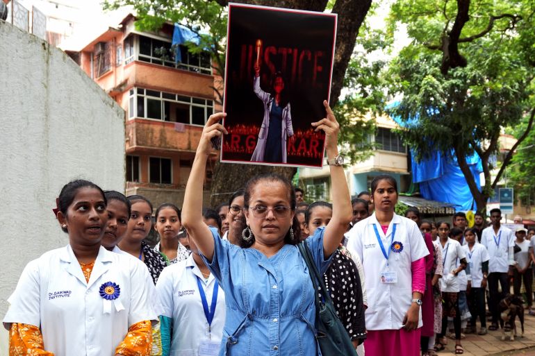 Doctors and residents hold posters and shout slogans during a protest condemning the rape and murder of a trainee medic at a government-run hospital in Kolkata, at a ground in Mumbai, India, August 18, 2024. REUTERS/Hemanshi Kamani