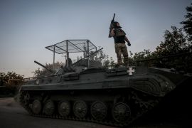 A serviceman of the 24th Mechanized Brigade named after King Danylo of the Ukrainian Armed Forces monitors the sky as a BRM-1K infantry fighting vehicle prepares to fire towards Russian troops at a front line, amid Russia&#039;s attack on Ukraine, near the town of Chasiv Yar in the Donetsk region, Ukraine, August 17, 2024 [Oleg Petrasiuk/Press Service of the 24th King Danylo Separate Mechanized Brigade of the Ukrainian Armed Forces/Handout via Reuters]