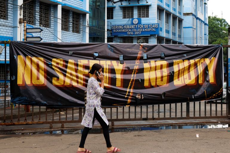 A woman walks past a closed gate of R G Kar Medical College and Hospital in Kolkata