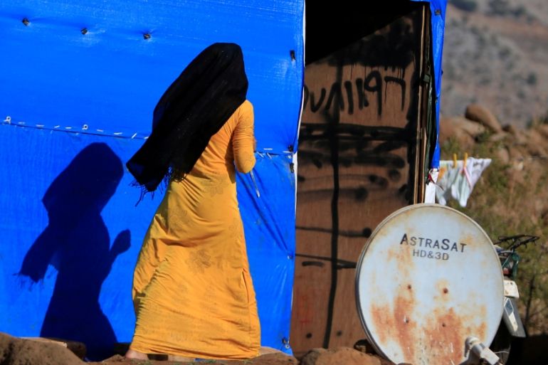 A Syrian woman is seen near a tent in a refugee camp in Marjayoun