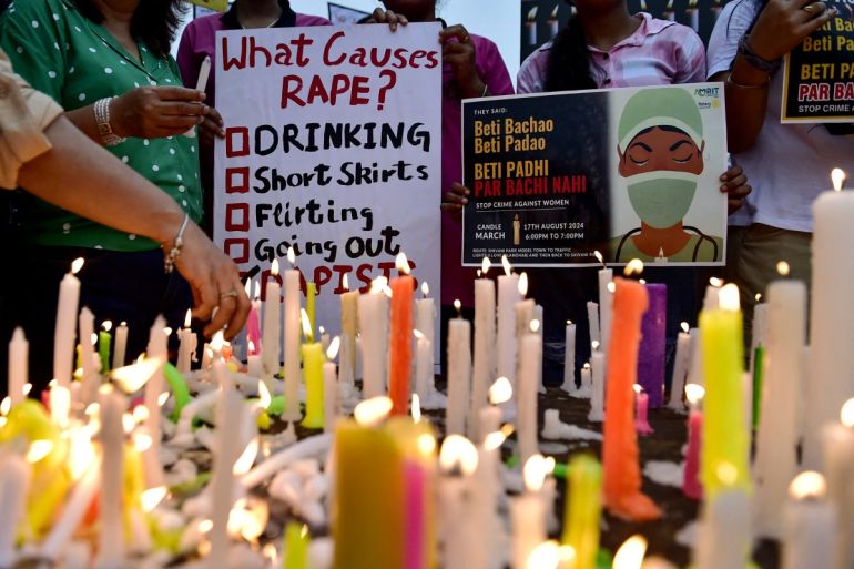 Medical professionals light candles and hold posters during a demonstration amid nationwide strike by doctors to condemn the rape and murder of a young medic from Kolkata