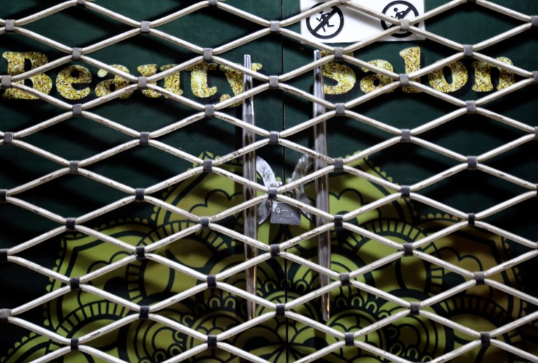 A lock is seen on a beauty salon door after Taliban