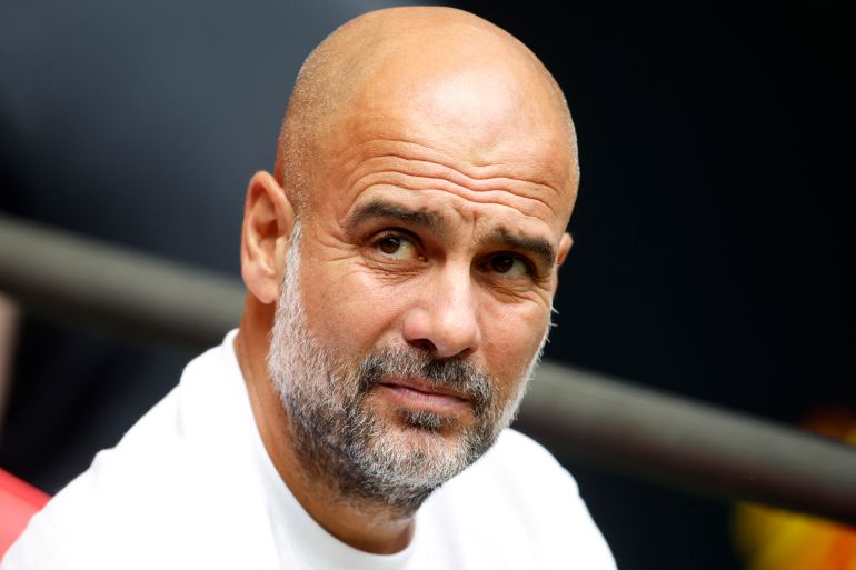 Manchester City's head coach Pep Guardiola watches his team during the FA Community Shield final soccer match between Manchester City and Manchester United at Wembley Stadium in London, Saturday, Aug. 10, 2024. (AP Photo/David Cliff)