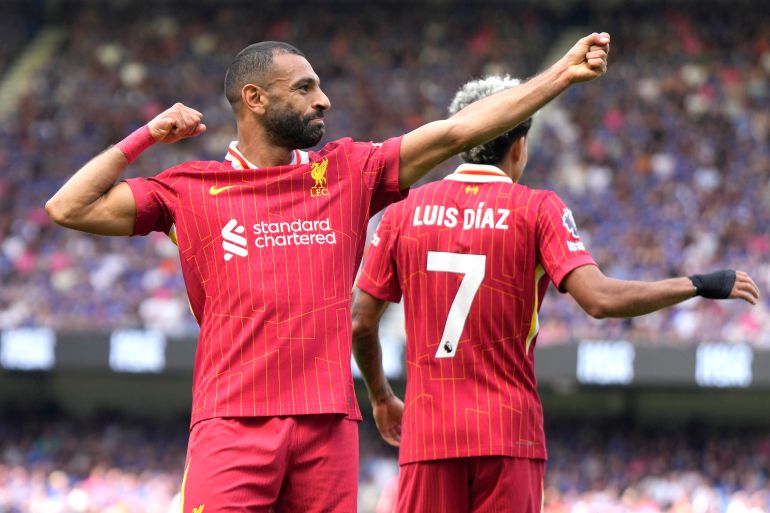 Liverpool's Mohamed Salah, left, celebrates after he scores his side's second goal during the English Premier League soccer match between Ipswich Town and Liverpool at Portman Road stadium in Ipswich, England, Saturday, Aug. 17, 2024. (AP Photo/Alastair Grant)