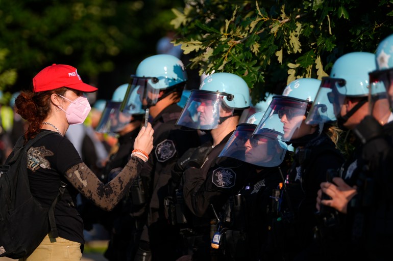 Riot police line up against protesters outside the DNC.