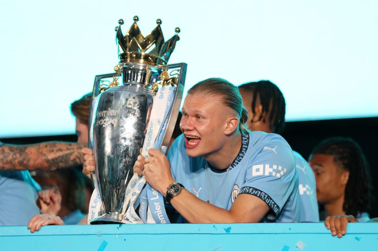 Player with EPL trophy.