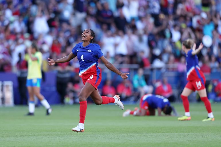 PARIS, FRANCE - AUGUST 10: Naomi Girma #4 of Team United States celebrates victory in the Women's Gold Medal match between Brazil and United States of America during the Olympic Games Paris 2024 at Parc des Princes on August 10, 2024 in Paris, France. (Photo by Justin Setterfield/Getty Images)